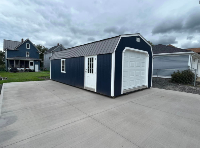 naval barn with white trim with charcoal roof
